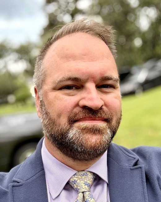 Ben Tobias, founder of Catalyst19, in a blue blazer outdoors.